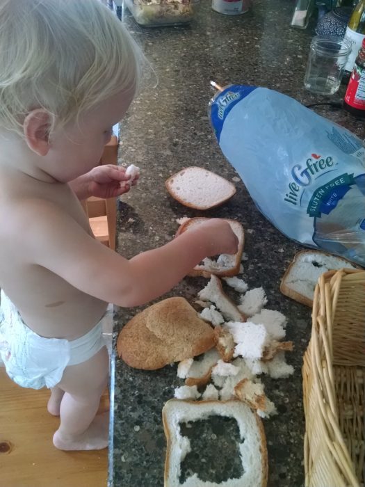 The baby, hard at work making... umm... bread crumbs. 