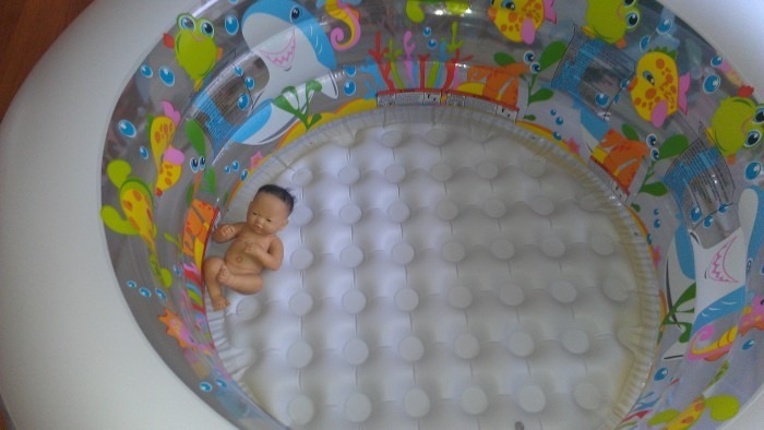 The blown up but empty birth pool and realistic baby doll that served as my focal point during labor